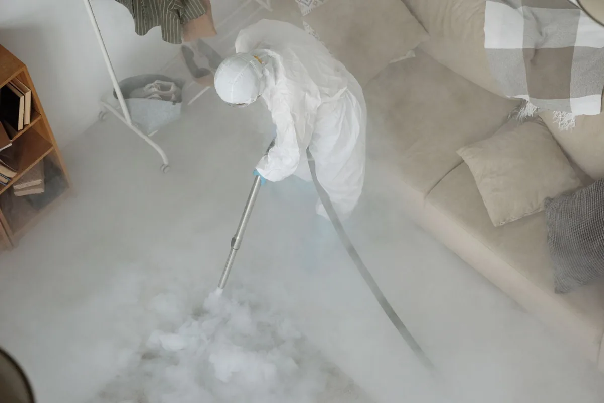 Biohazard cleanup technician in protective equipment, Oakhurst, NJ